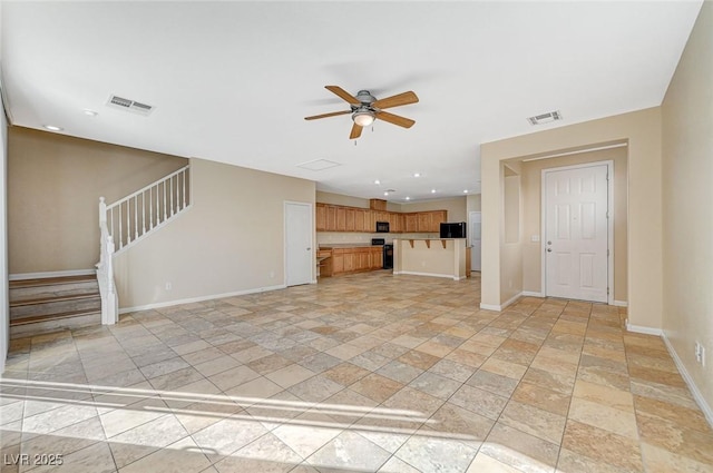 unfurnished living room with ceiling fan