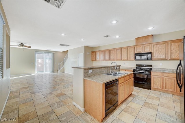 kitchen with sink, ceiling fan, light stone counters, black appliances, and light brown cabinetry