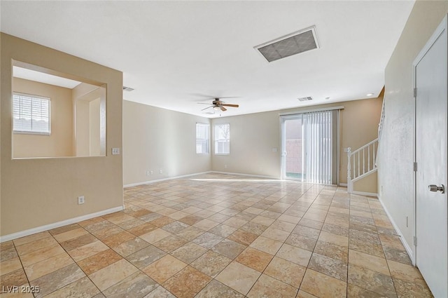 unfurnished room featuring ceiling fan and a healthy amount of sunlight