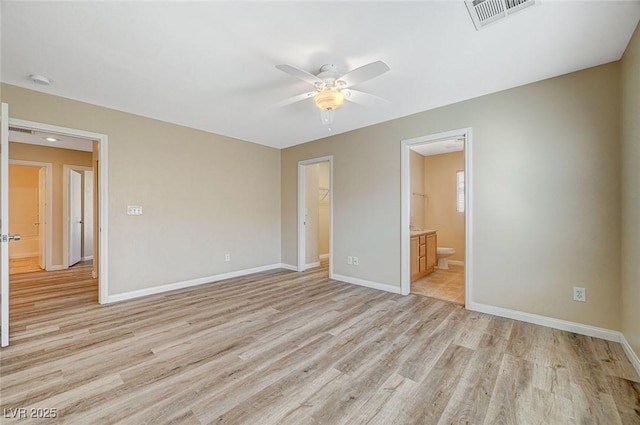 unfurnished bedroom with connected bathroom, ceiling fan, and light wood-type flooring