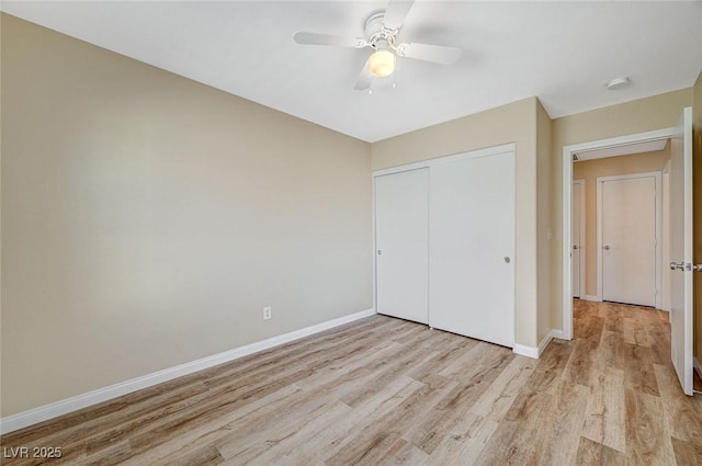 unfurnished bedroom featuring ceiling fan, light wood-type flooring, and a closet