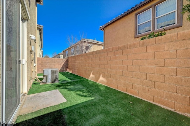 view of yard featuring a patio area and central air condition unit