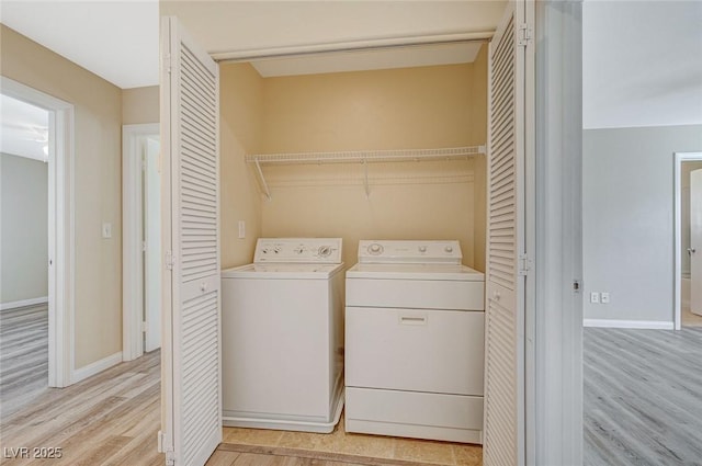 laundry room featuring washer and dryer and light hardwood / wood-style floors