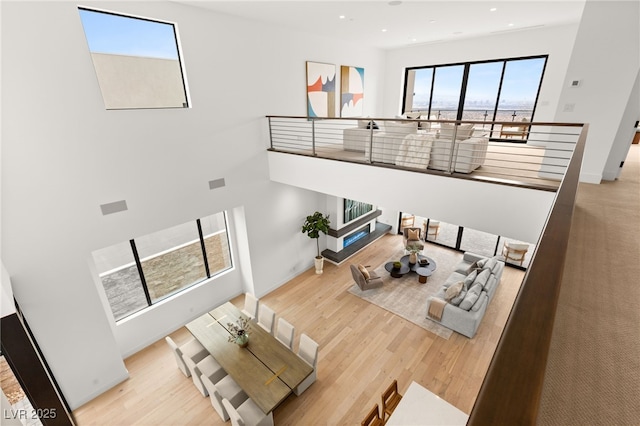 living room featuring baseboards, wood finished floors, and recessed lighting