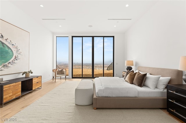 bedroom with light wood-type flooring and recessed lighting