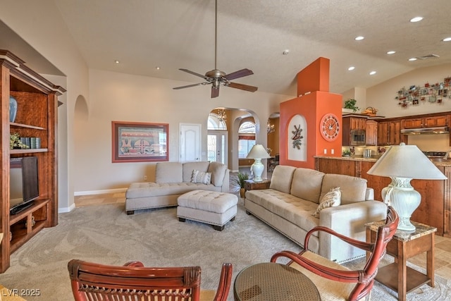 carpeted living room featuring ceiling fan, lofted ceiling, and a textured ceiling