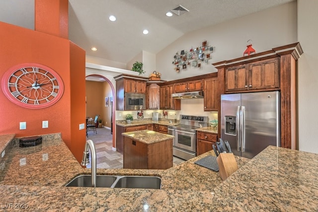 kitchen with sink, stone countertops, high vaulted ceiling, kitchen peninsula, and stainless steel appliances