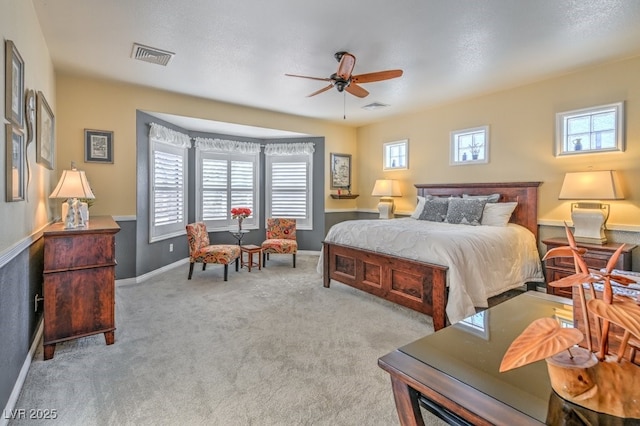 bedroom featuring light carpet and ceiling fan