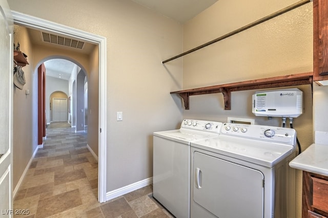 clothes washing area with washer and clothes dryer