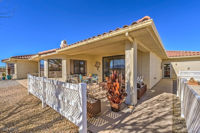 back of property with a patio