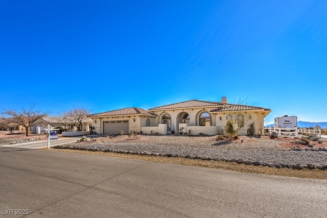 mediterranean / spanish-style home featuring a garage