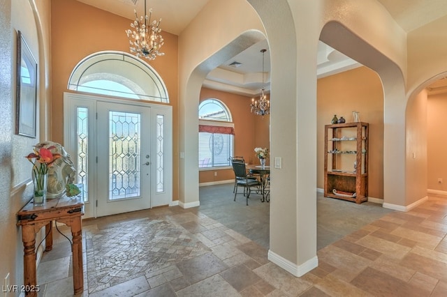 foyer entrance with a high ceiling and an inviting chandelier