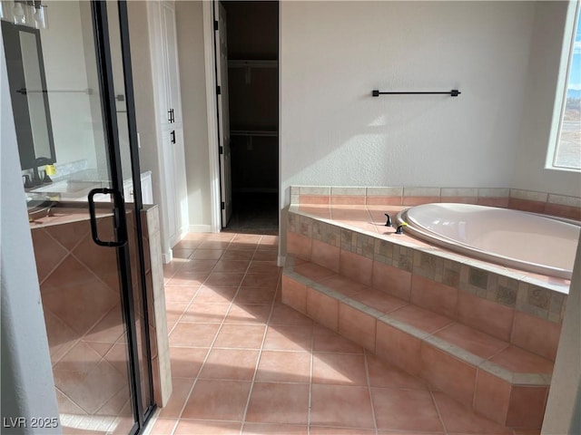 bathroom featuring tile patterned floors and separate shower and tub