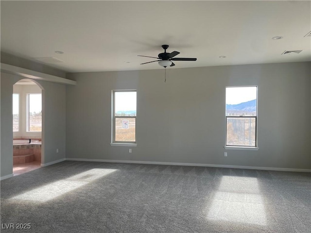 carpeted empty room featuring ceiling fan