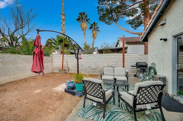 view of patio with grilling area and an outdoor hangout area