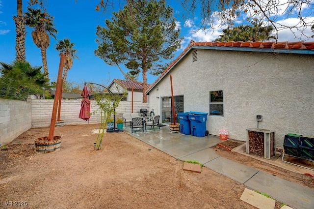 view of yard featuring a patio area and central air condition unit