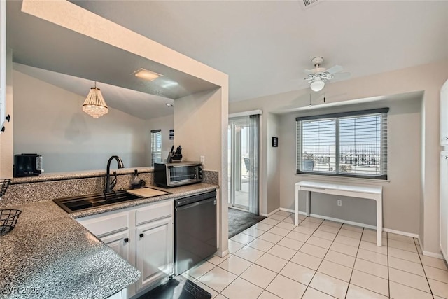 kitchen featuring pendant lighting, light tile patterned floors, sink, dishwasher, and white cabinets