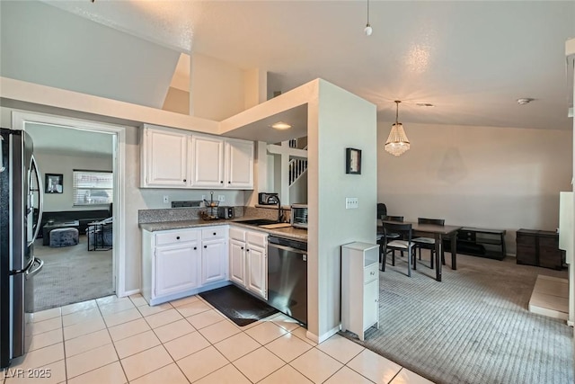 kitchen with white cabinetry, light colored carpet, black dishwasher, and stainless steel refrigerator