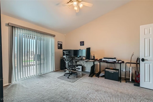 carpeted office with lofted ceiling and ceiling fan