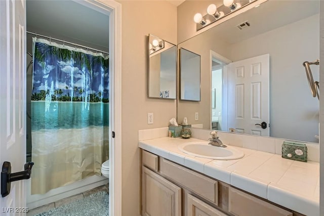 bathroom with vanity, tile patterned flooring, a shower with curtain, and toilet