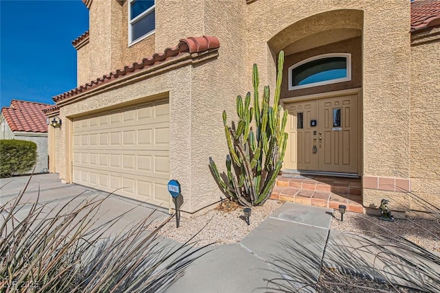 view of exterior entry featuring a garage