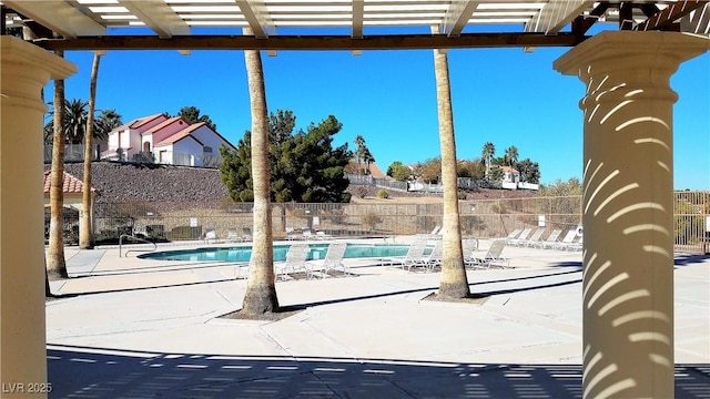 view of patio / terrace featuring a community pool and a pergola