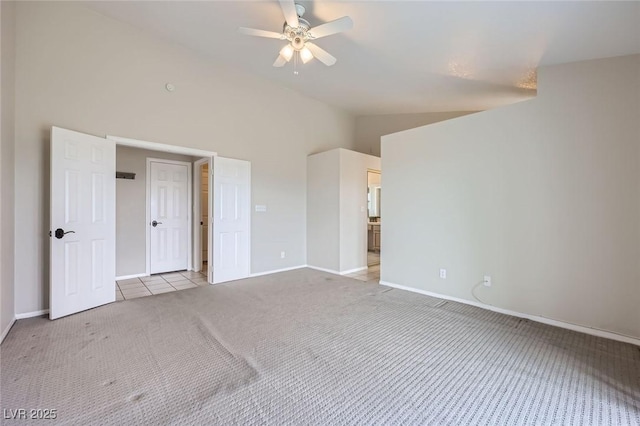 unfurnished bedroom featuring carpet flooring, ceiling fan, high vaulted ceiling, and baseboards