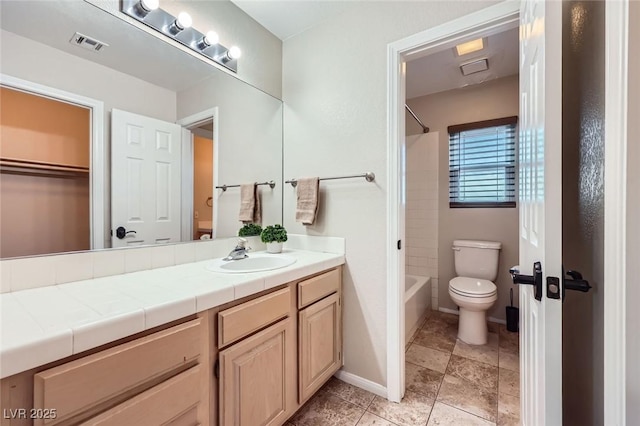 full bathroom with visible vents, toilet, vanity, baseboards, and shower / bathtub combination