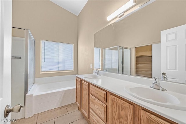 bathroom featuring tile patterned flooring, vanity, and separate shower and tub