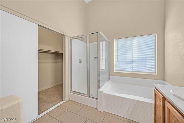 bathroom with vanity, independent shower and bath, and tile patterned flooring