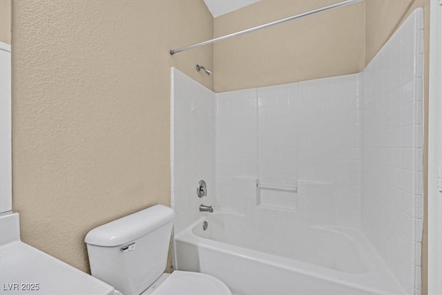 bathroom featuring shower / washtub combination and toilet