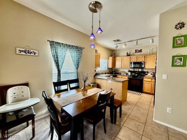 tiled dining space with rail lighting