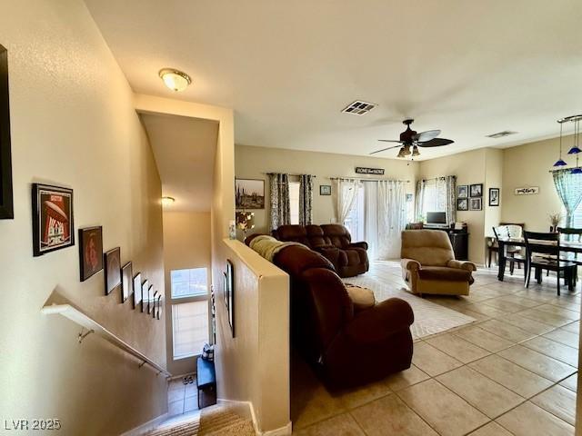 tiled living room featuring ceiling fan