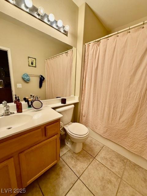 bathroom with vanity, toilet, and tile patterned flooring