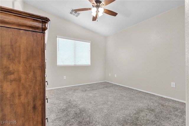 unfurnished room featuring ceiling fan, lofted ceiling, and carpet