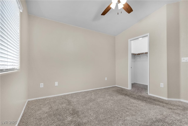 9323 Leaping Deer Pl Unit 102, Las Vegas, NV 89178 - unfurnished bedroom with carpet floors, vaulted ceiling, a spacious closet, and baseboards