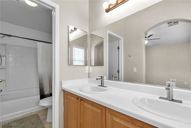 full bathroom featuring shower / bath combination with curtain, vanity, ceiling fan, toilet, and tile patterned floors