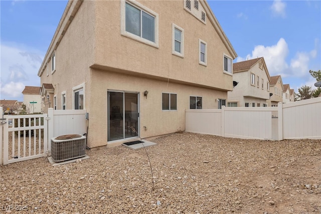 9323 Leaping Deer Pl Unit 102, Las Vegas, NV 89178 - back of house featuring a fenced backyard, stucco siding, and cooling unit