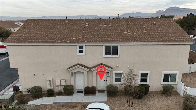 9323 Leaping Deer Pl Unit 102, Las Vegas, NV 89178 - view of front of home with a mountain view, stucco siding, and roof with shingles