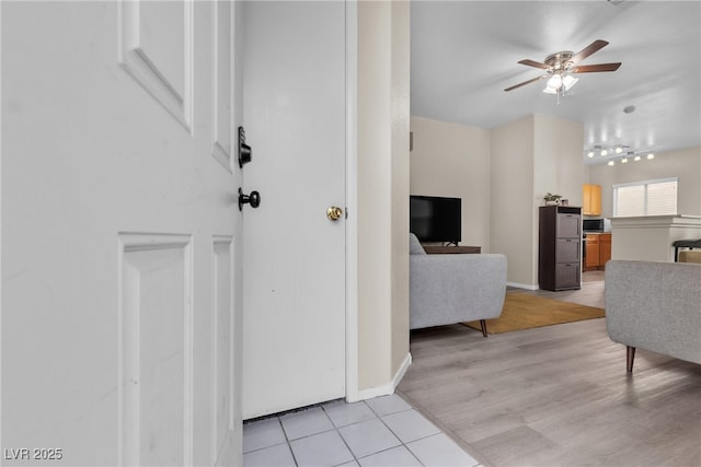 living room with ceiling fan and light wood-type flooring