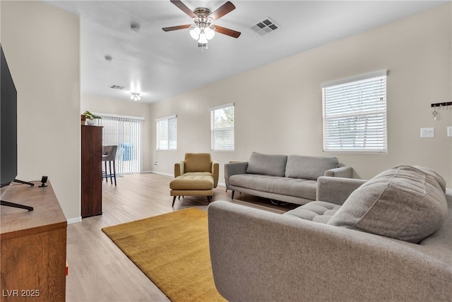 9323 Leaping Deer Pl Unit 102, Las Vegas, NV 89178 - living room with light wood-style floors, ceiling fan, and baseboards