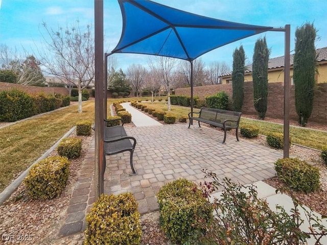 surrounding community with a patio and a lawn