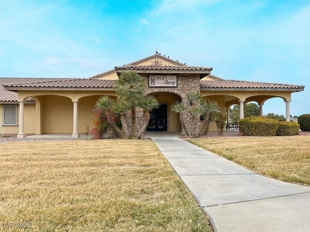 mediterranean / spanish house featuring a front lawn