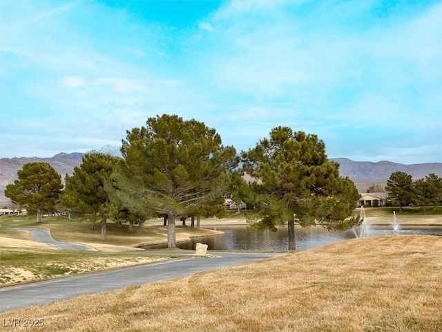 surrounding community featuring a yard and a water and mountain view