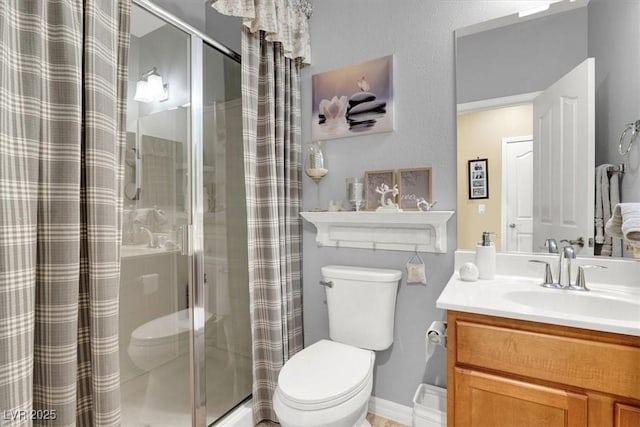 bathroom with vanity, curtained shower, and toilet