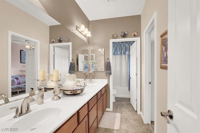 bathroom featuring vanity, tile patterned floors, and toilet