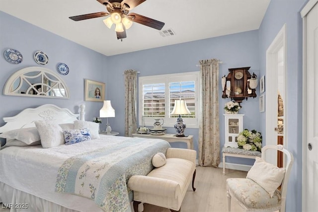 bedroom with light hardwood / wood-style floors and ceiling fan