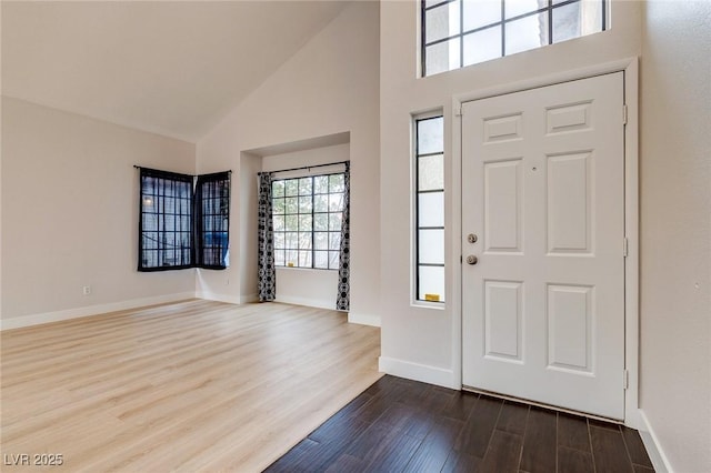 entryway with high vaulted ceiling and hardwood / wood-style floors