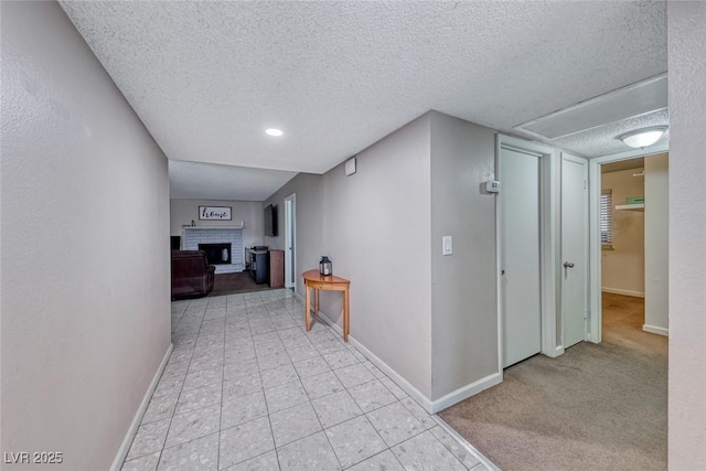 hall with a textured ceiling