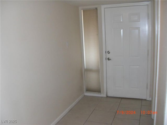 entryway with light tile patterned floors